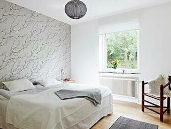 Modern Bedroom With One Wall Covered In Gray Wallpaper Branches