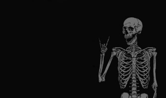 A Skeleton Holding Knife In The Dark Wallpaper