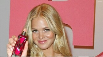 Erin Heatherton Smiling And Showing Perfume Wallpaper