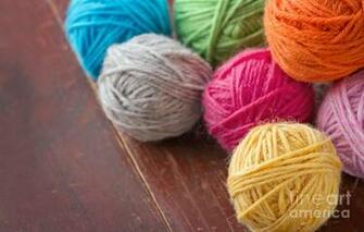 Balls Of Woolen Yarn On Old Wooden Background Photograph