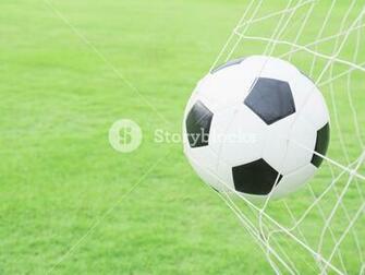 Shooting Shot Football In Goal Net With Green Grass Field