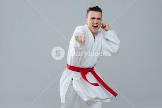 Image Of Handsome Sportsman In Kimono Practicing At Karate While