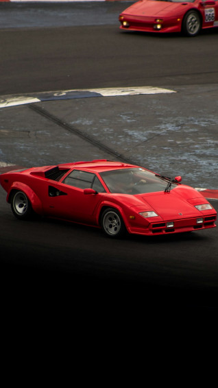 A Red Sports Car Driving Down Race Track Photo Cdmx Image