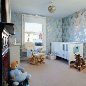 This Pretty Nursery Is Decorated With Pale Blue And Gold Wallpaper For