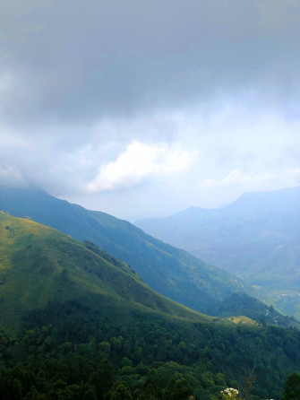 Green Mountains Under White Clouds During Daytime Photo