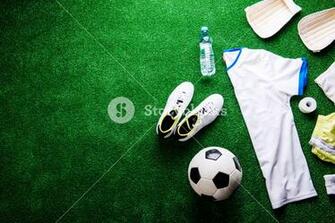 Soccer Ball Cleats And Various Football Stuff Against Artificial