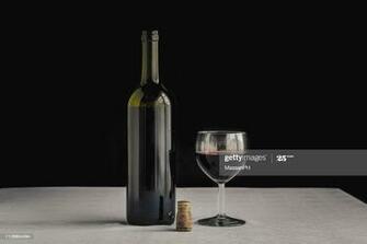 Bordeaux Bottle On White Tablecloth And Black Background Next To A