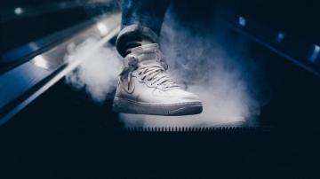 Person Wearing White Nike Air Force Mid Rise Shoes While