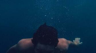Man Submerged On Body Of Water Photo Image