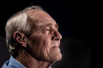 Old Man With Wrinkle Face And Gray Hair Looking Out Using A