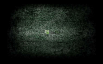 Linux Mint Kde Logo On A Poorly Lit Blue Tinted Concrete Wall