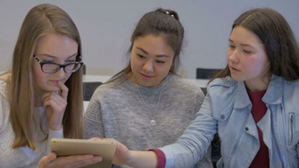 Best Student Showing Something To Her Classmate Wallpaper