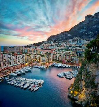 Aerial Photography Of High Rise Building Near Boats And Mountain
