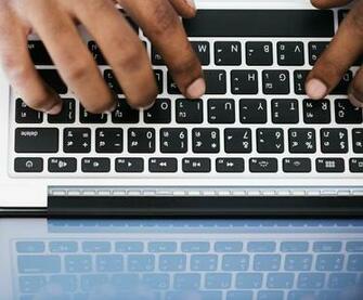 Person Typing On White And Black Laptop Computer Stock