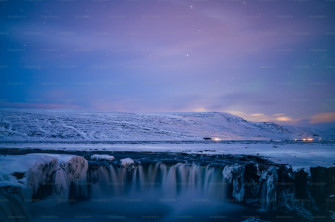 A Frozen Waterfall In The Middle Of Snowy Landscape Photo