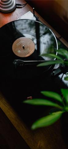 Black Turntable On Brown Wooden Table iPhone Wallpaper