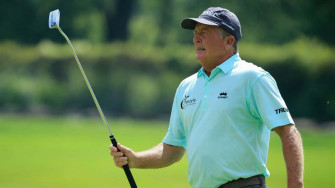 Professional Golfer Fred Funk Analyzing His Golf Club During A Wallpaper