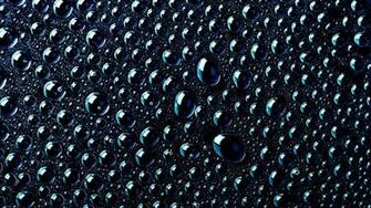 Water Drops On A Black Surface Wallpaper