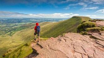 Walker At Corn Du Summit Overlooking Pen Y Fan South Wales