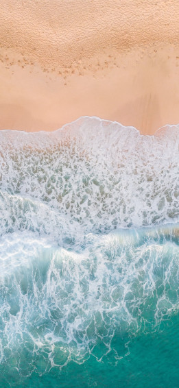 Aerial Photography Of Waves Splashing On White San iPhone X Wallpaper