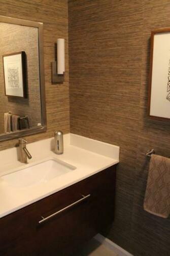 Powder Room With Grasscloth Wallpaper Walnut Stained Cabinetry