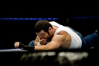 Jimmy Wang Yang Lying In The Ring With His Hands On Nose