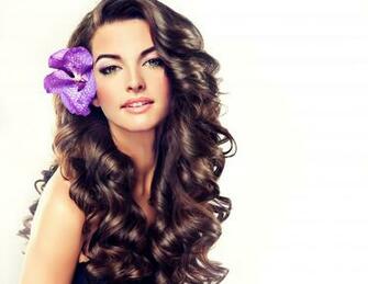 Beautiful Girl With Long Curly Brown Hair Flower In