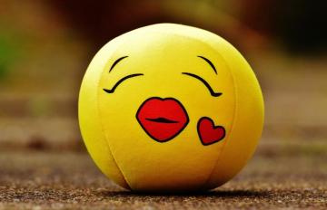 Yellow Ball Emoji On The Ground Image
