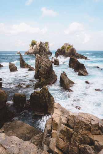 Time Lapse Photography Of Rock Formations By The Sea Under Cloudy