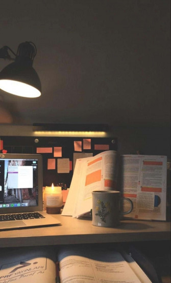 A Man Is Working At His Desk Wallpaper