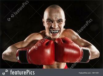 Young Man Kickboxing On Black With Kapa In Mouth Stock Image
