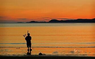A Bagpiper On Arisaig Beach In Scotland Colstravel