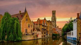 Buildings And Church Along A Canal In Bruges Belgium HD Wallpaper