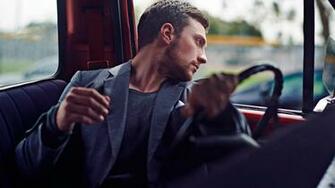 The Man Behind Wheel Of Car Looking Out Window