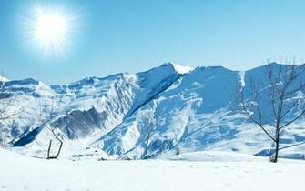 Sun Over Snow Covered Mountains Wallpaper