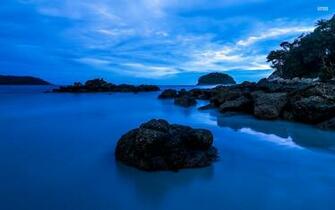 Deep Blue Water Black Rocks Wallpaper