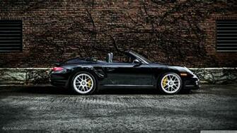 Black Porsche Turbo S Cabriolet By A Brick Wall