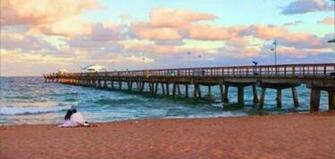 Couple Sitting On The Beach At Sunset Fort Lauderdale Florida Usa