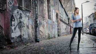 Young Girl Standing On The Street In Slums Wallpaper And