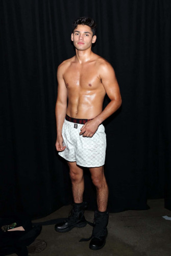 A Man In White Shorts Standing Front Of Black