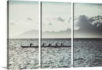 Men Paddle An Outrigger Canoe Off Tahiti Island With Moorea