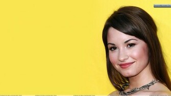 Demi Lovato Smiling Cute Face Closeup And Yellow Background Wallpaper