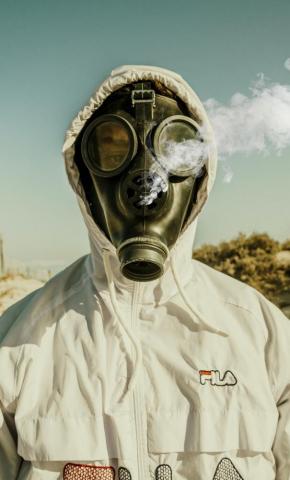 Person Wearing White And Blue Gas Mask Photo Houmt Souk