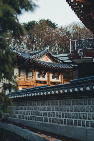 Brown And White Temple Near Green Trees During Daytime Photo
