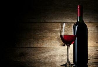 Wine Glass And Bottle On A Wooden Background Vinotherm
