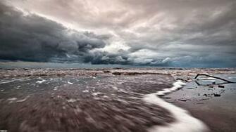 Tide Coming In Under Stormy Skies Wallpaper