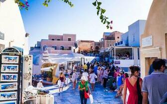 People Walking At Santorini Under Clear Blue Sky Image