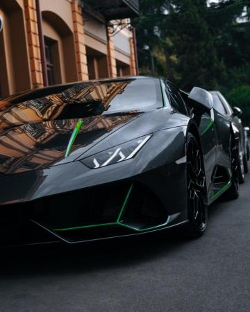 Black And White Lamborghini Aventador Parked On Gray Asphalt Road