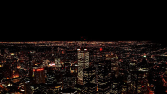 An Aerial Of The City Lights At Night From High Up In Skyscrapers Wallpaper