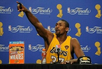 Ron Artest Acknowledges Someone In The Background As He Sits Next To A
